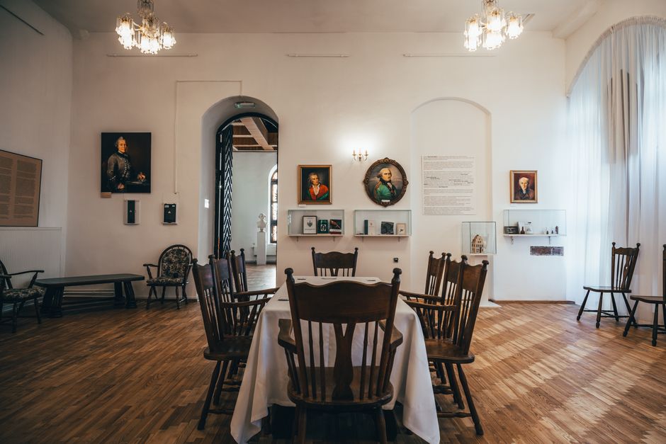 A stylish dining area with vintage art and elegant wooden furniture, perfect for luxury interiors.