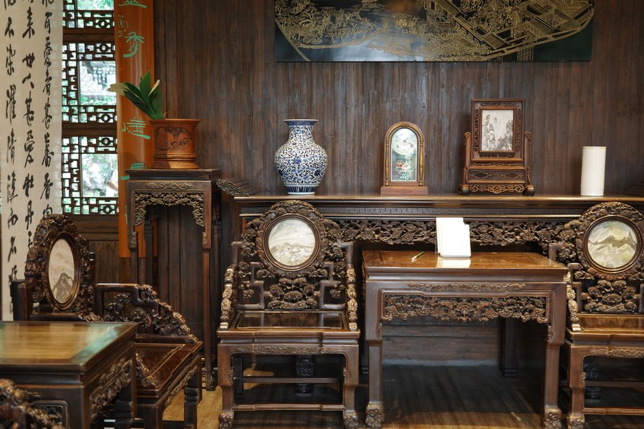 Beautiful Chinese antique furniture in an elegant room with traditional decor and intricate carvings.